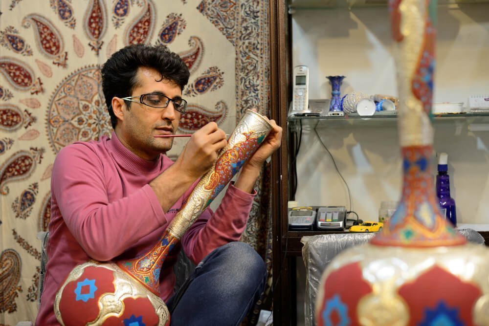 Persian craftsman working in his workshop. Khata'i Persian Art