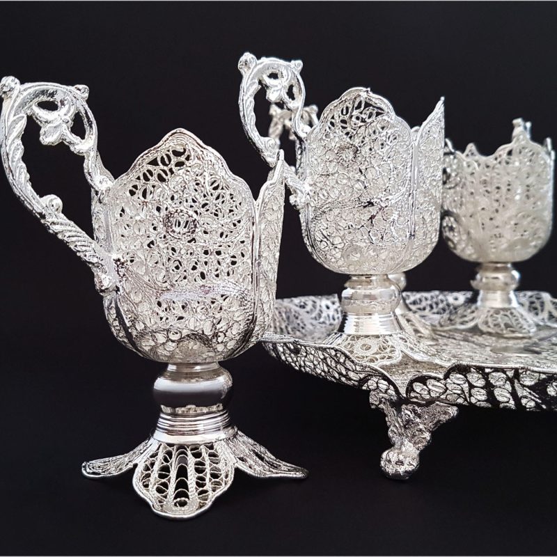 Silver teaware set showcasing intricate Persian designs by Craftestan