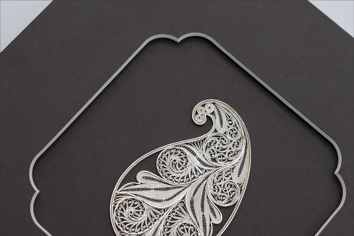 Image of the Persian filigree paisley wall art - sterling silver paisley within a protective glass layer.