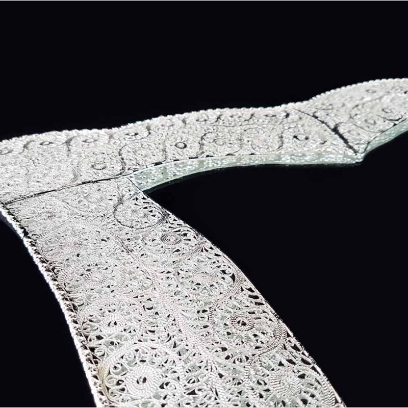 Handmade Persian mirror with intricate silver-coated copper filigree patterns.