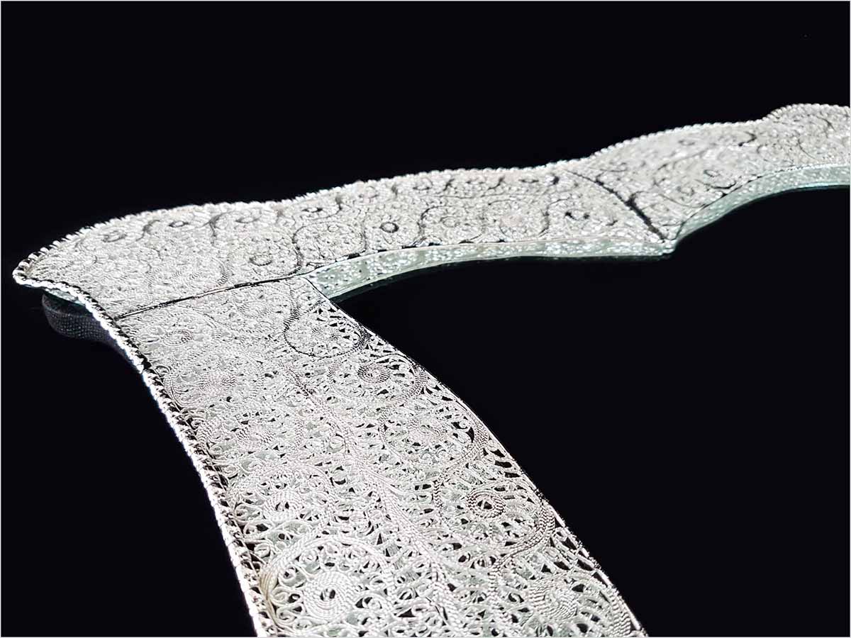 Handmade Persian mirror with intricate silver-coated copper filigree patterns.