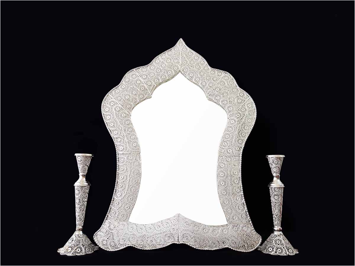 Handmade Persian mirror with intricate silver-coated copper filigree patterns.