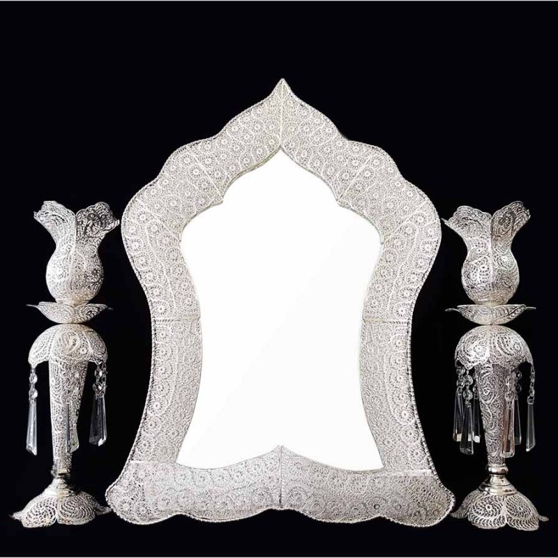 Handmade Persian mirror with intricate silver-coated copper filigree patterns.