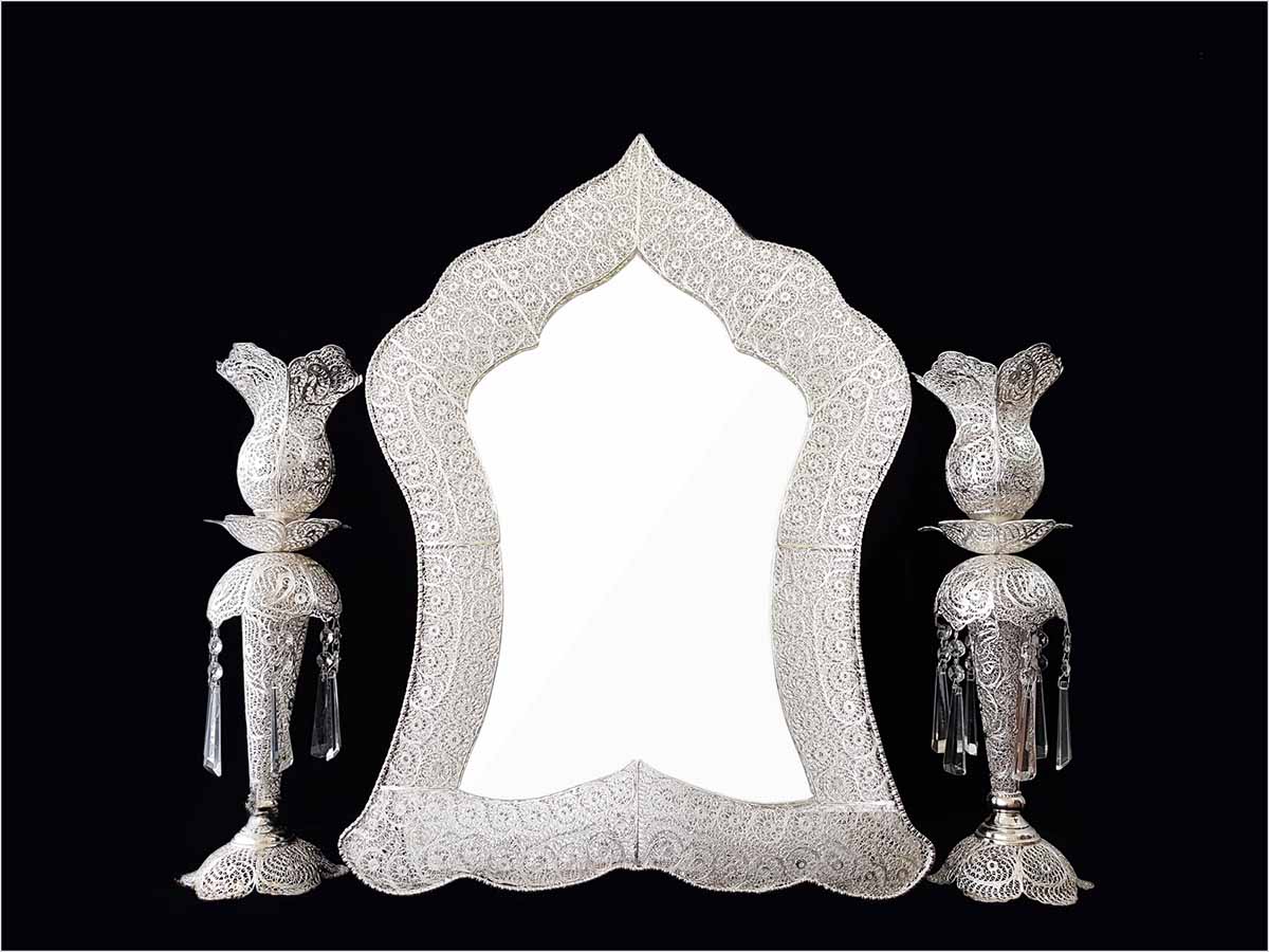 Handmade Persian mirror with intricate silver-coated copper filigree patterns.