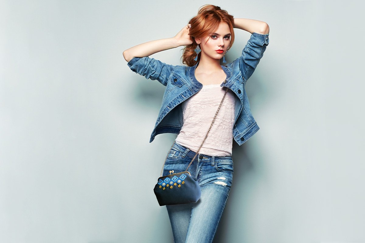 Baluchi coin-work handbag featuring shimmering coins and navy blue embroidered diamonds on a black background.