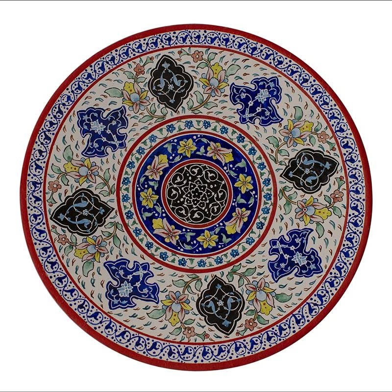 Image of a white enamel plate beautifully adorned with intricate Persian floral motifs in vibrant reds, encapsulating the rich artistry of Isfahani craftsmanship.