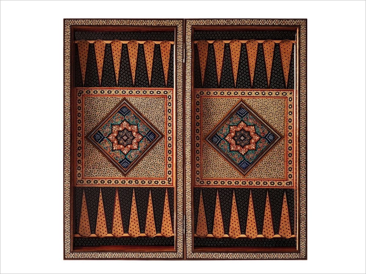This exquisite Persian marquetry backgammon is a true work of art. Measuring 50 cm in length and width, it boasts a rich combination of brown, gold, and black tones. The intricate oriental geometric pattern adds to its sophisticated charm, making it not only a functional game board, but also a stunning decorative piece