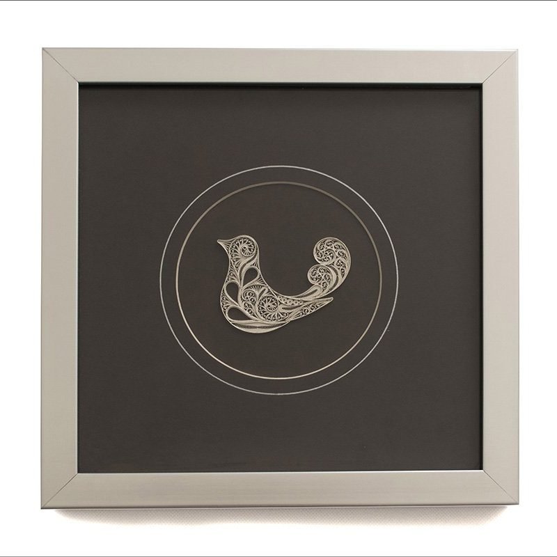 Image of the Persian filigree nightingale wall art - a sterling silver nightingale within a protective glass layer.