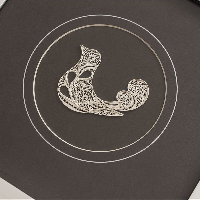 Image of the Persian filigree nightingale wall art - a sterling silver nightingale within a protective glass layer.