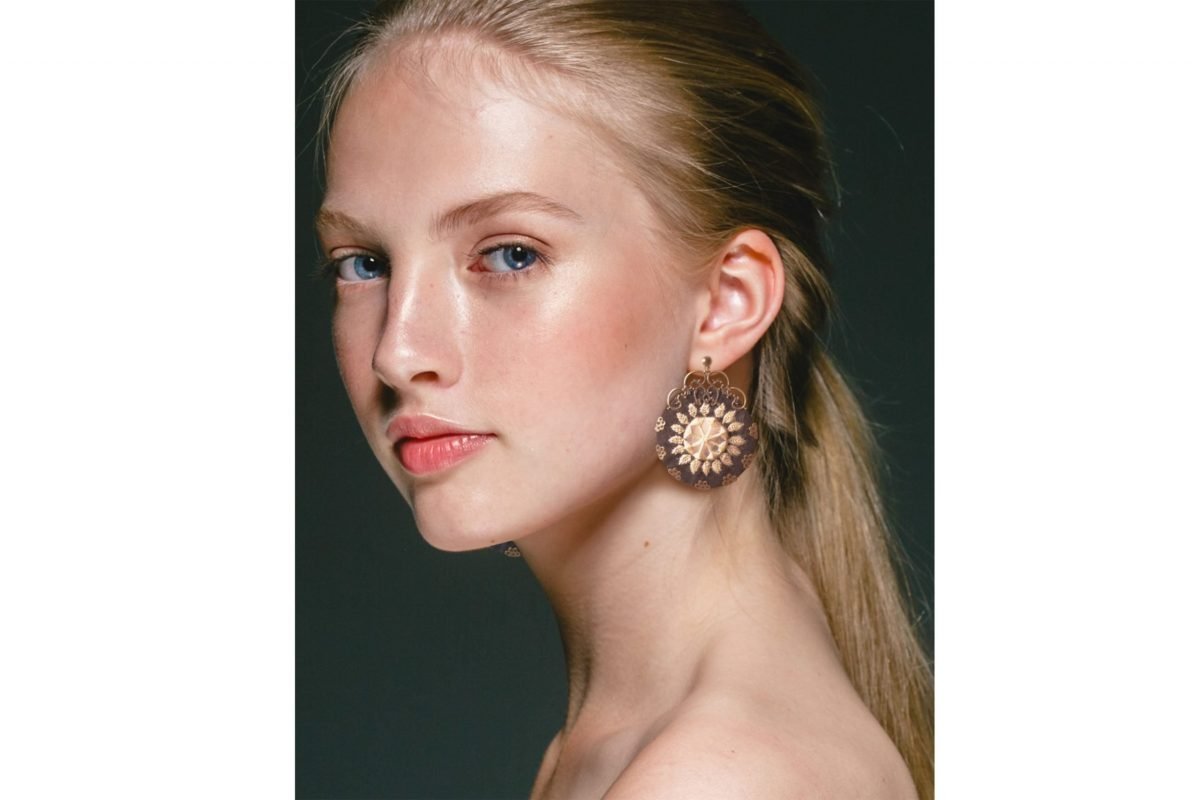 Image of Baluchi embroidered circular earrings with a traditional design in black and yellow colours.