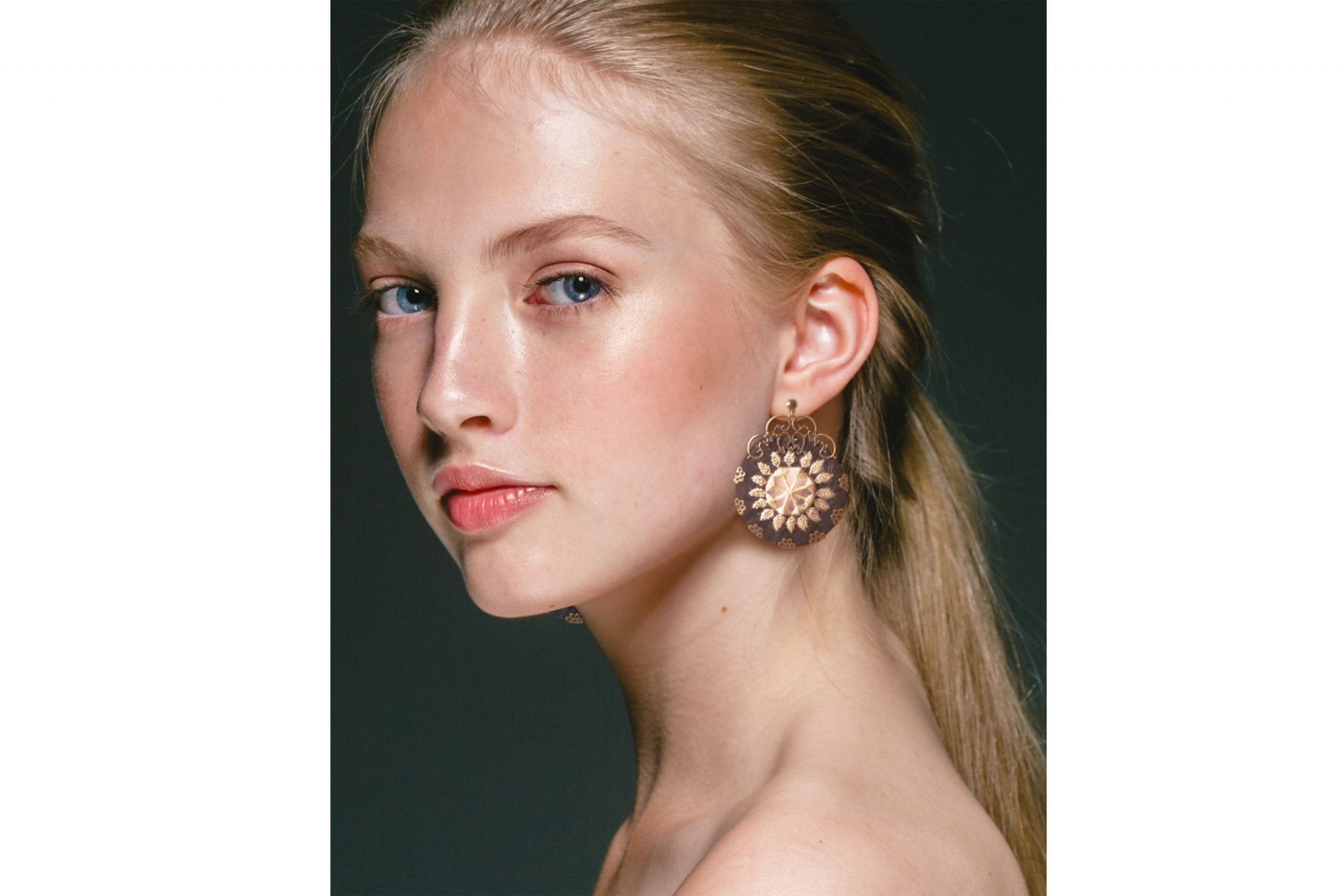 Image of Baluchi embroidered circular earrings with a traditional design in black and yellow colours.