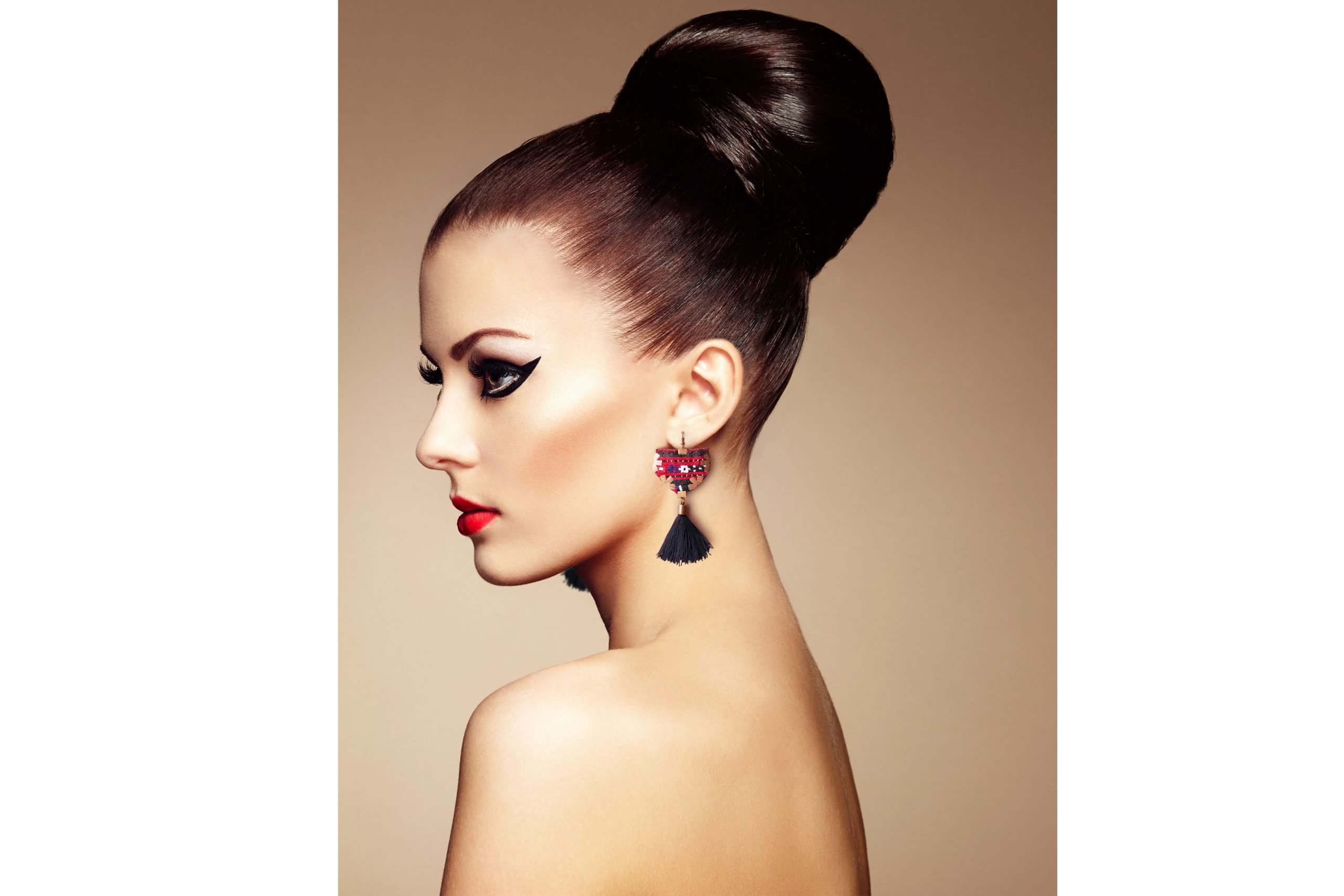 Bohemian Baluchi accessory set featuring a necklace, earrings, and bracelet with detailed hand embroidery and black tassels on a neutral background.