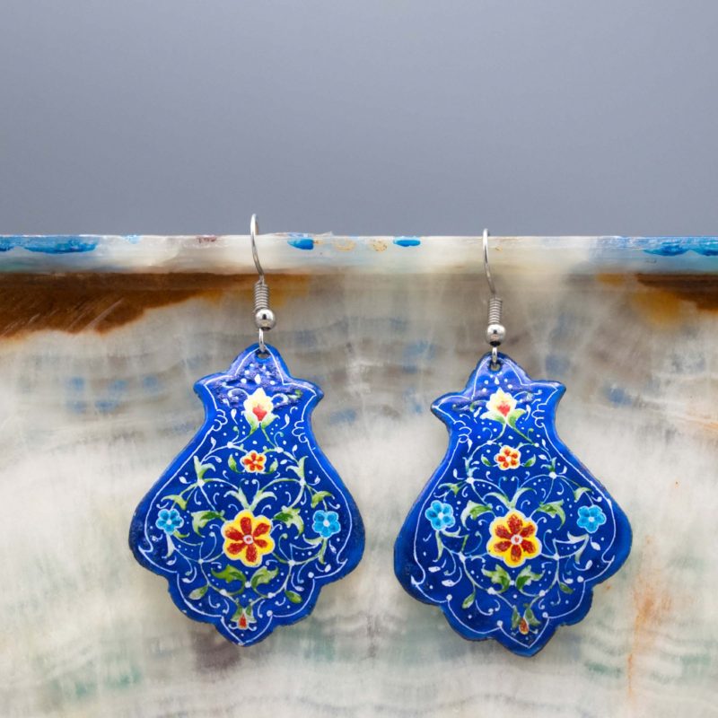 A front view of Blue Persian Enamel Watercolour Painting Earrings, showcasing a hand-painted Persian garden design on an enamelled copper body with a titanium hook.