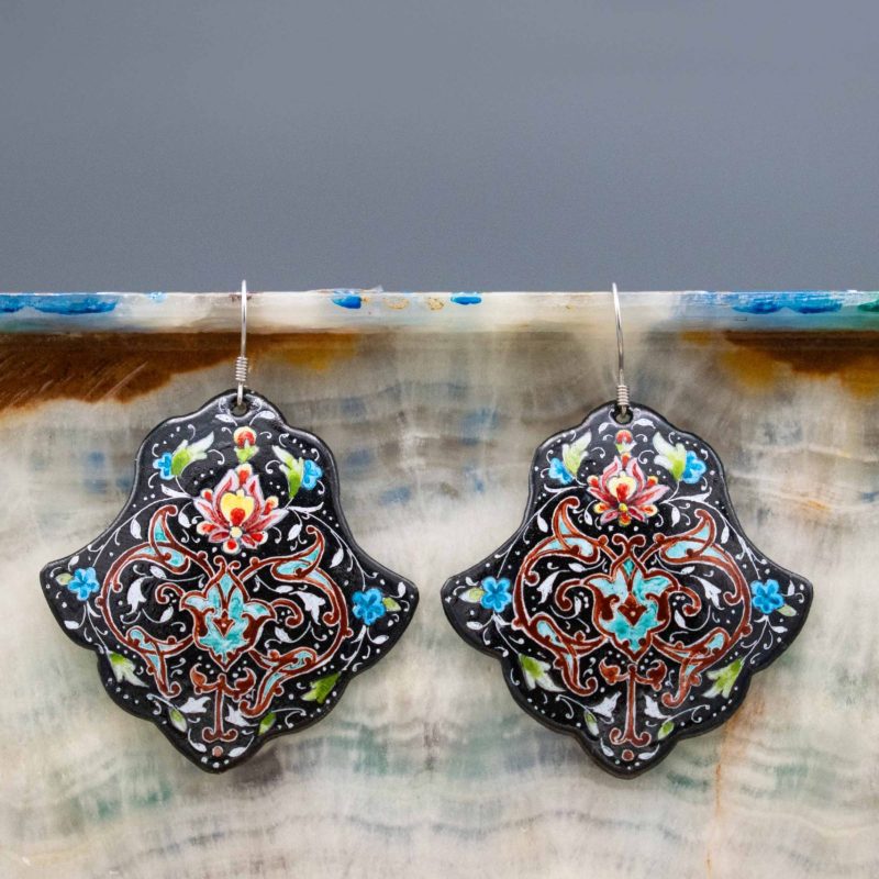 Enamel watercolour painting earrings with Persian foliate and floral pattern design, skillfully hand-painted by a master artisan. Made of enamelled copper with titanium hooks. Each earring measures 5cm in height and 2.5cm in width. Black colour.