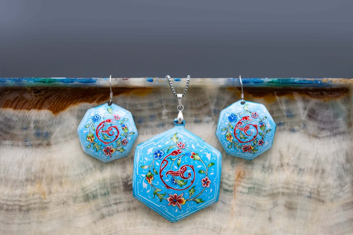 Enamel watercolour painting earrings and necklace with Persian garden design, skillfully hand-painted by a master artisan. Made of enamelled copper with titanium hooks. The earrings measure 5cm in height and 2.5cm in width, while the necklace measures 7cm in height and 5cm in width. Sky blue colour.