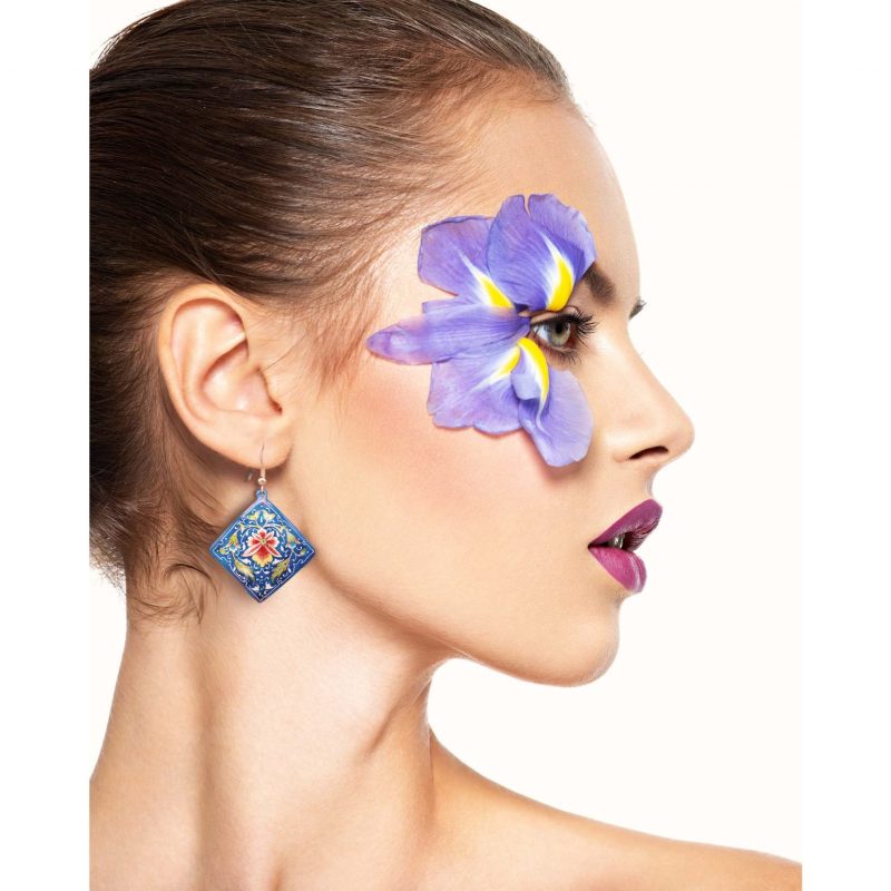 Model wearing Hand-Painted Persian Earrings with a floral design made of enamelled copper and silver hook.