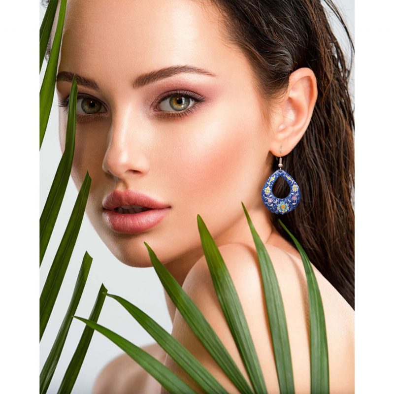 Portrait of a beautiful woman wearing drop eye-shaped Persian enamel earrings with Islimi floral design, hand-painted on enamelled copper body and silver hook.
