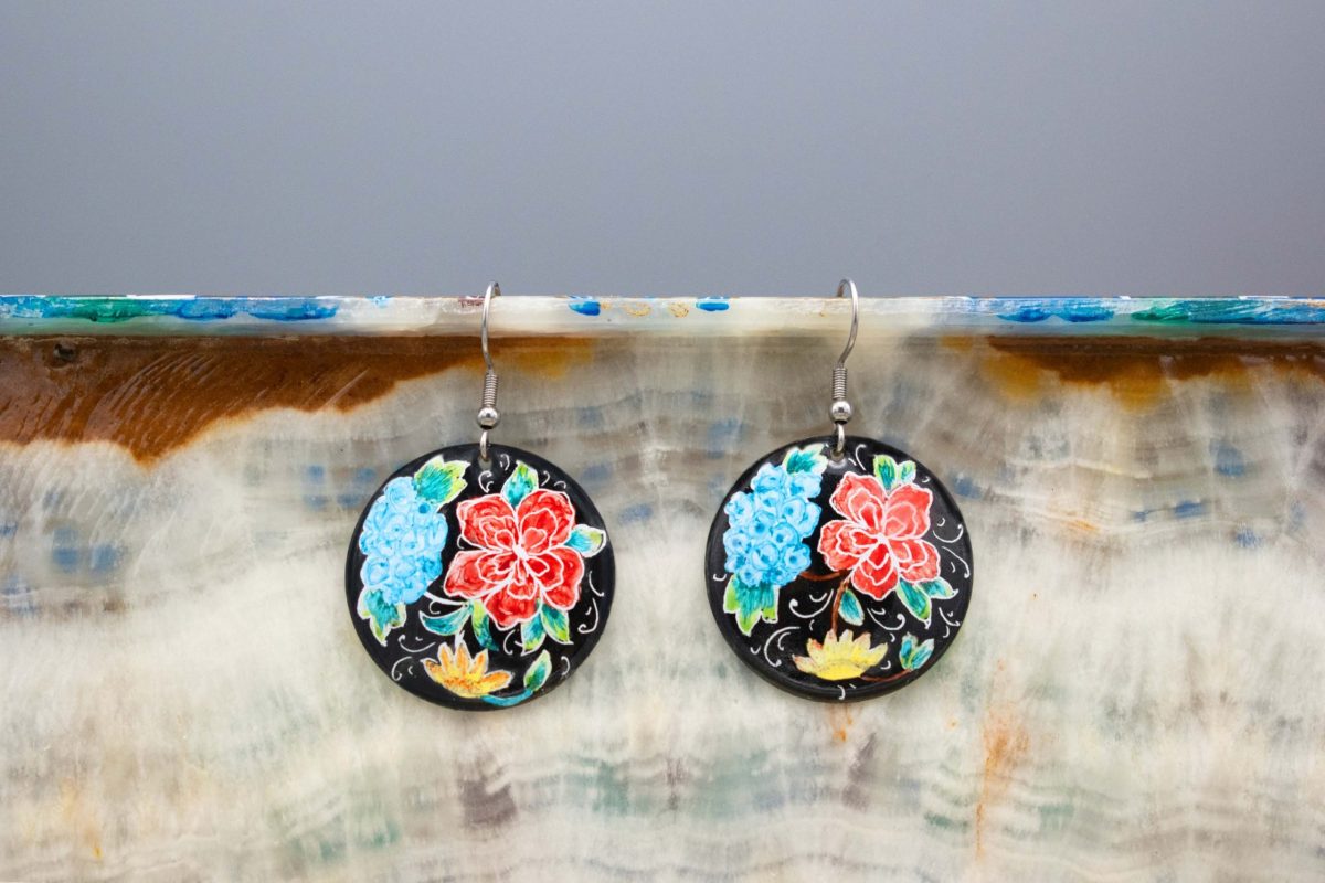 Front view of Hand-Painted Persian Enamel Watercolour Painting Earrings, featuring a unique Persian garden design in blue, red, and black hues. Made of enamelled copper with a titanium hook. Each earring measures 5cm in height and 2.5cm in width.