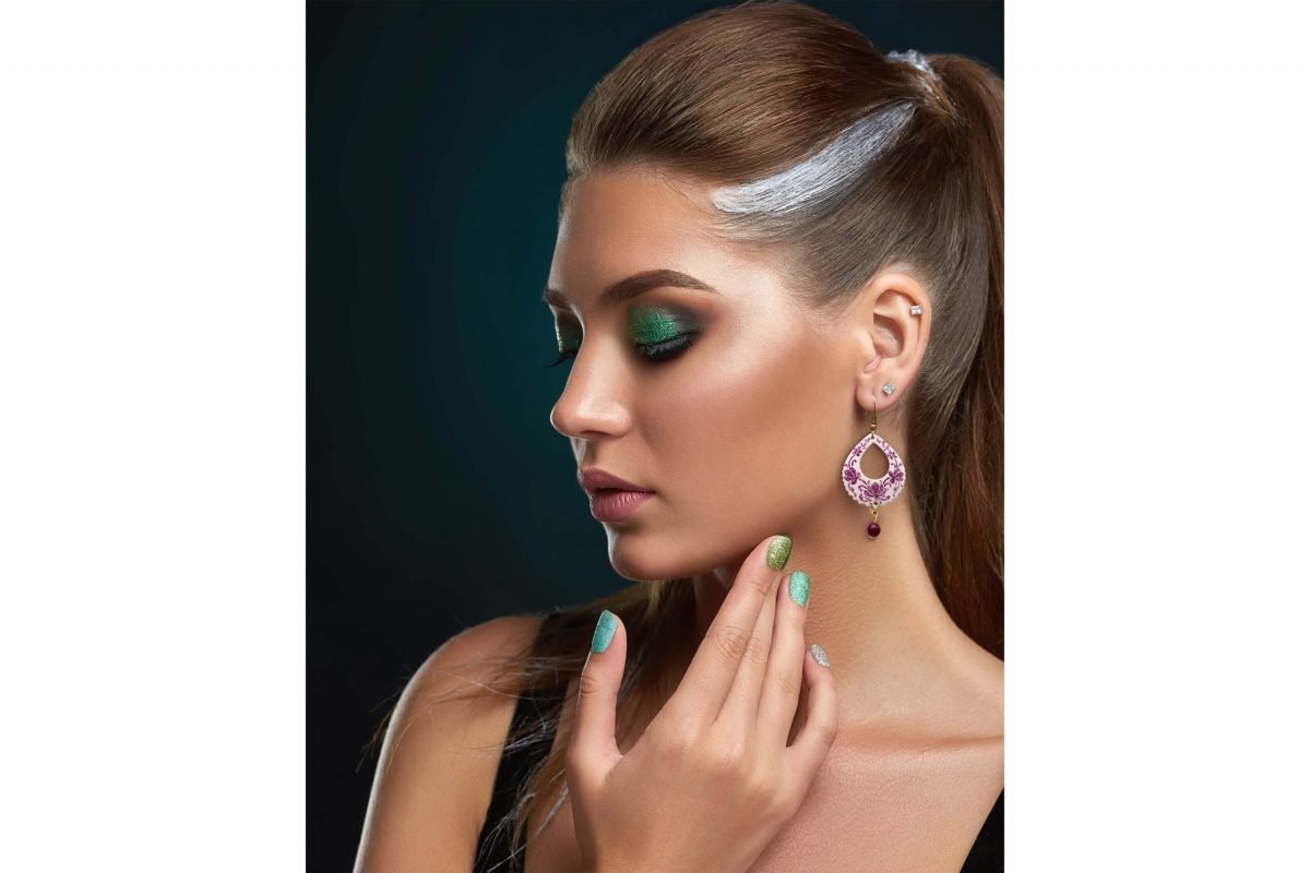 Portrait of a beautiful model wearing Persian Enamel Watercolour Painting Earrings, featuring enamelled copper body, hand-painted Persian pattern, and white and purple colours.