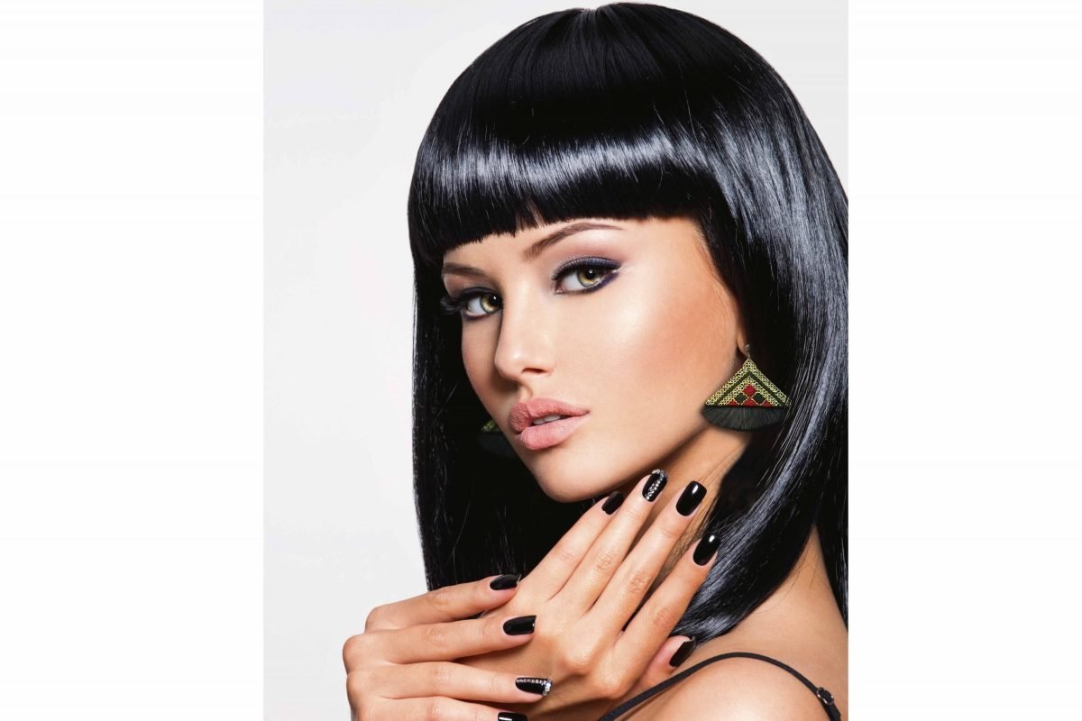 Elegant Baluchi Embroidered Earrings with geometric patterns and black tassels.