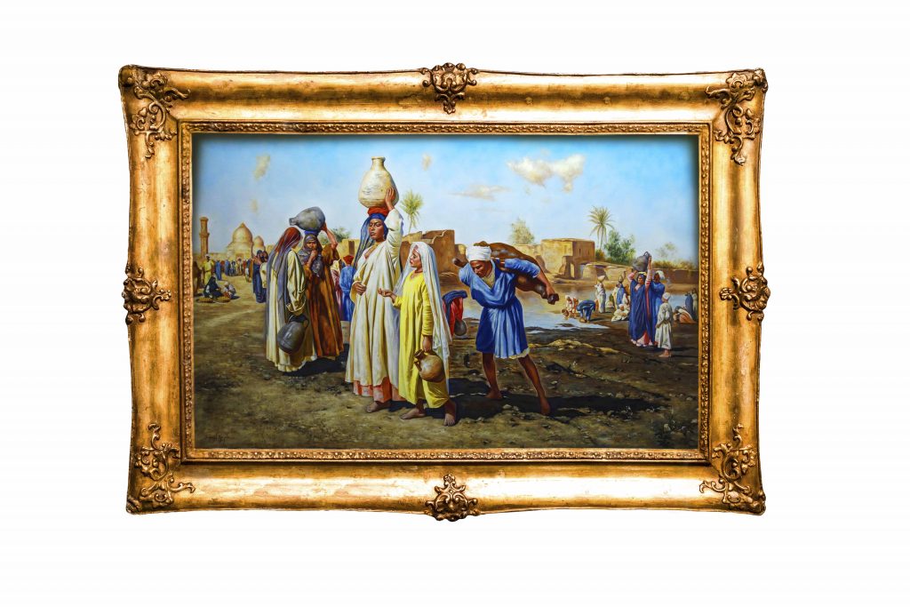 "Fetching Water" by Leopold Karl Müller, a painting depicting men and women collecting water from the river in a lively Egyptian village scene.