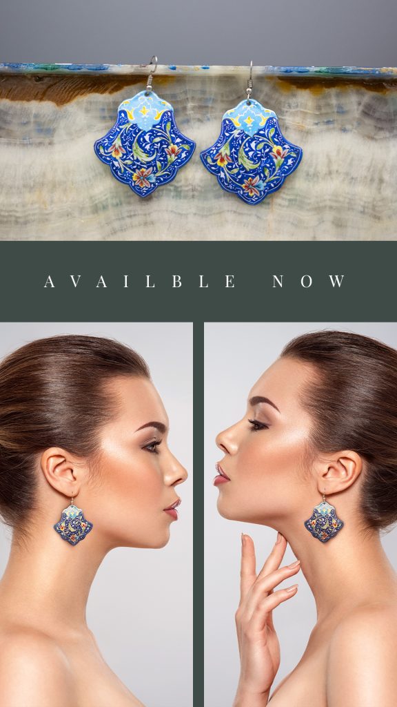 A portrait of a beautiful girl wearing a pair of bold Persian enamel jewellery featuring hand-painted azure blue floral designs, adding drama and complementing her stunning features.