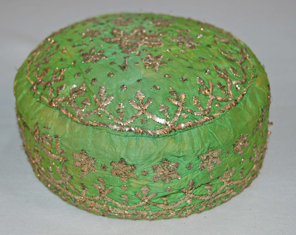 Woman's embroidered bridal skull-cap made of lime green taffeta silk with silver embroidery, lined with cream cotton. Persian fashion history 