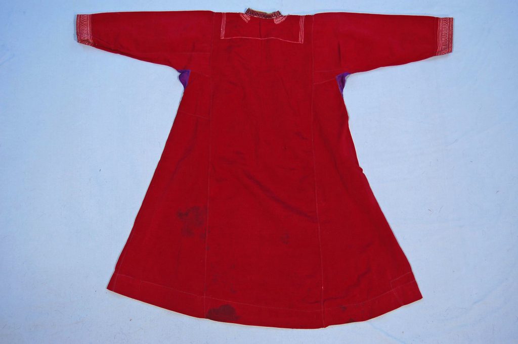 This beautifully crafted woman’s shift is made from cloth and adorned with coins, showcasing the intricate embroidery typical of Turkmen craftsmanship. The shift features detailed stitching that reflects the cultural heritage of the Turkmen ethnic group, blending functionality with artistry. Acquired in Iran, this garment exemplifies the rich textile traditions and decorative techniques prevalent in the region.