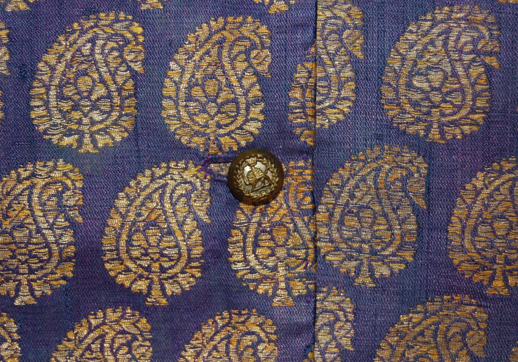Traditional Iranian Isfahani brocade jacket with lion and sun motifs in golden silk on purple satin.