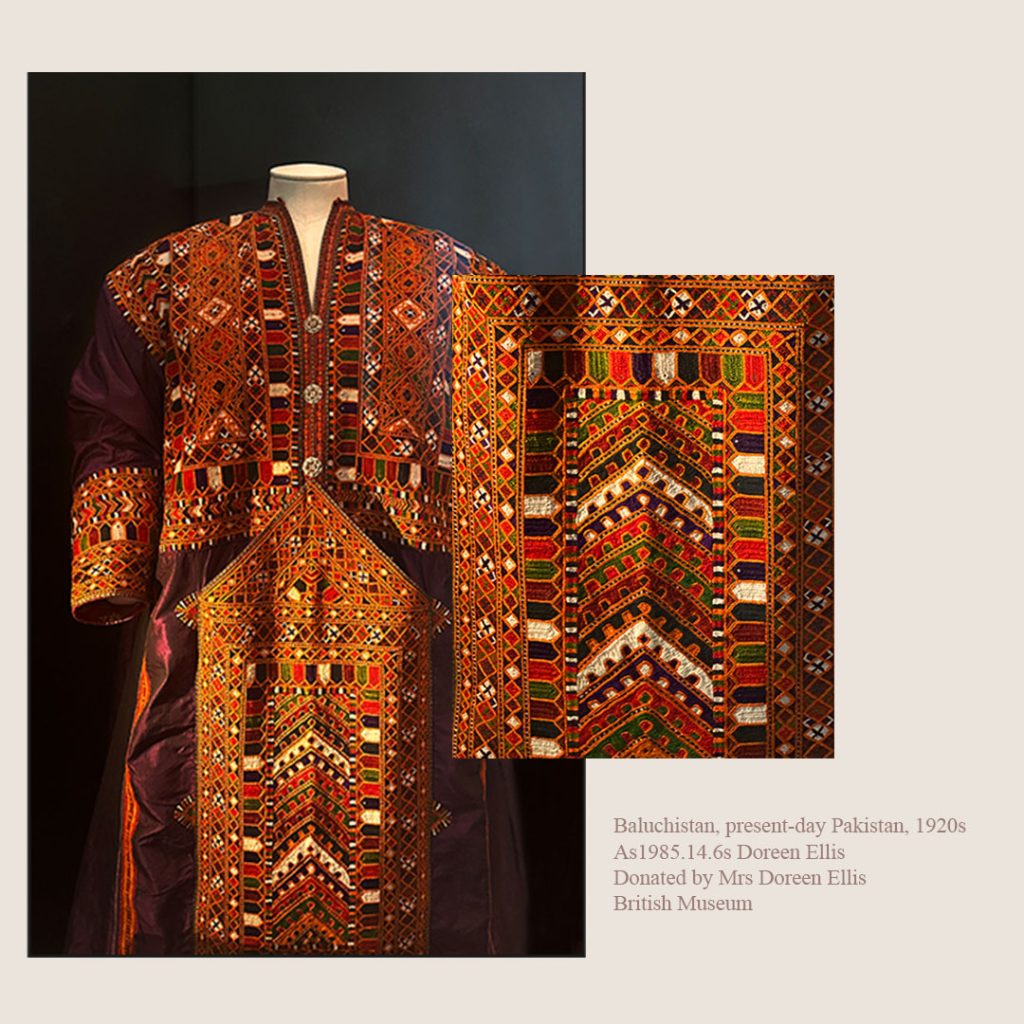 A photo of a Baluchi Pashk, a traditional calf-length dress worn by Baluch women, made of silk taffeta with exquisite multicolored embroidery and silver thread. The dress is adorned with metal embellishments along the front and worn with baggy trousers and a head-shawl, creating a stunning and elegant look.