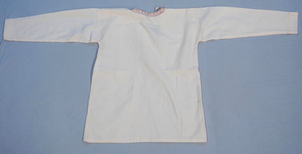 This traditional man's shirt, crafted from soft cotton, exemplifies the clothing styles of the Turkmen ethnic group. The shirt's simple yet functional design reflects the practical needs of everyday wear while also showcasing the cultural heritage of the Turkmen people. Acquired in Iran, this shirt serves as a testament to the craftsmanship and textile traditions prevalent in the region.