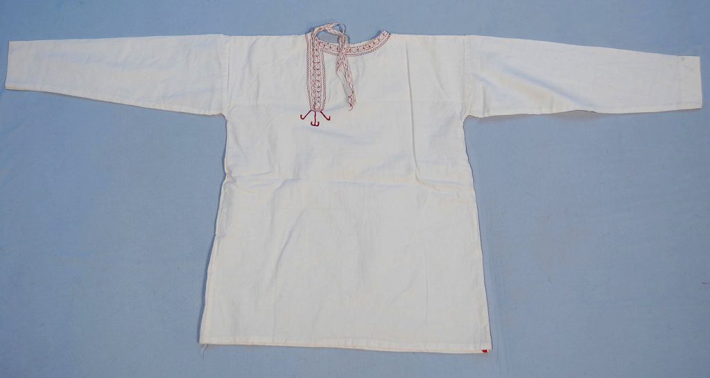 This traditional man's shirt, crafted from soft cotton, exemplifies the clothing styles of the Turkmen ethnic group. The shirt's simple yet functional design reflects the practical needs of everyday wear while also showcasing the cultural heritage of the Turkmen people. Acquired in Iran, this shirt serves as a testament to the craftsmanship and textile traditions prevalent in the region.