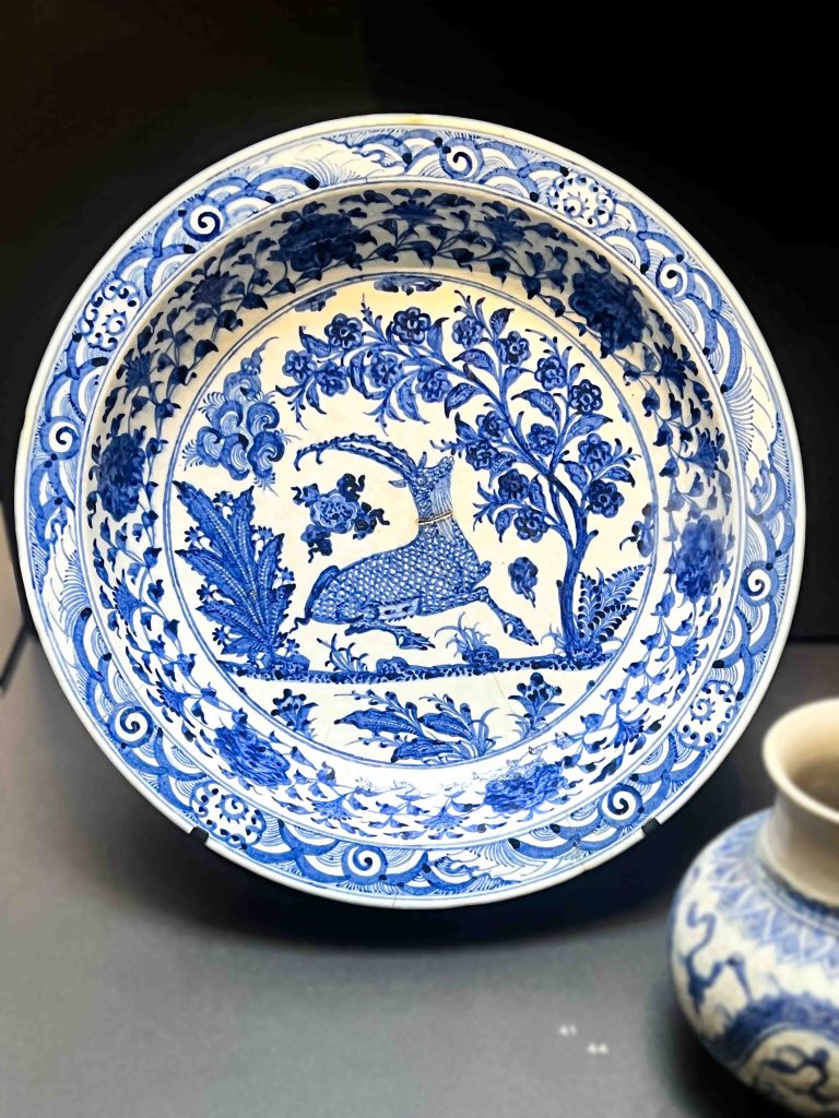 A remarkable Timurid pottery dish showcasing foliate decoration and a crouched cervid or bixie motif, crafted from glazed pottery. Khata'i Persian Art