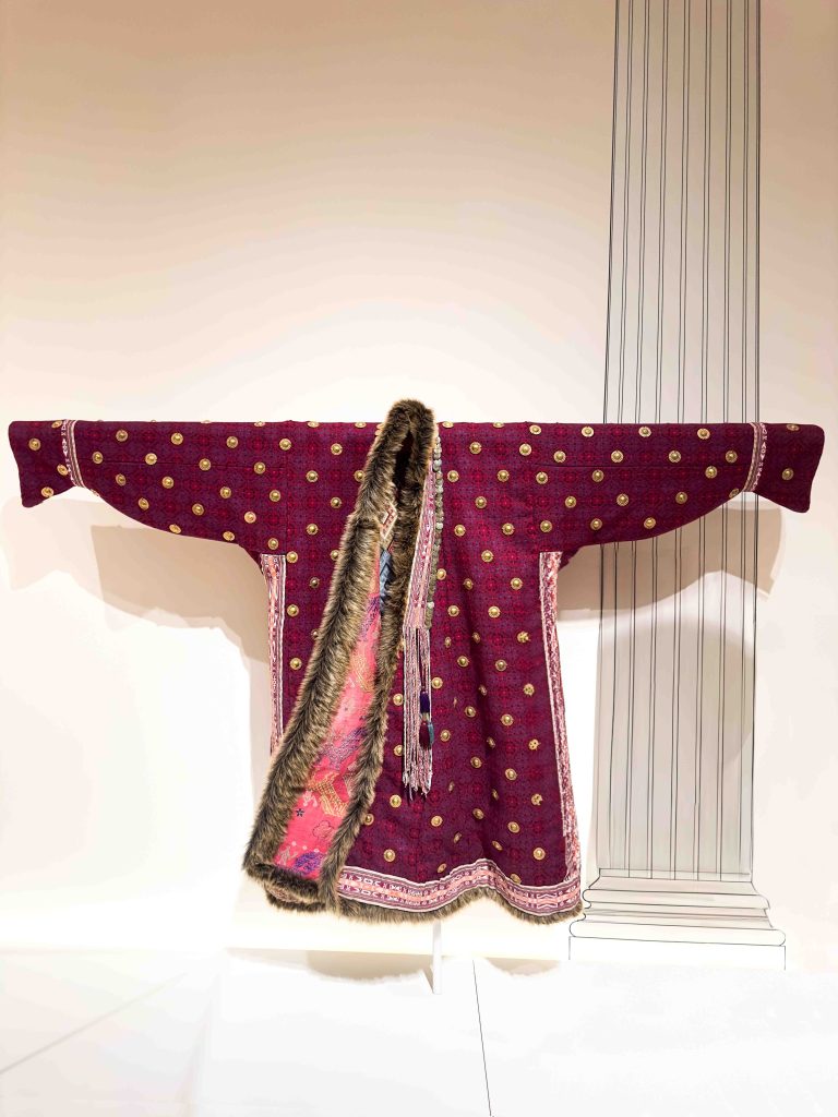 An image of the meticulously recreated Achaemenid riding costume, crafted from lamb's wool and faux fur and adorned with metallic appliqués, offering a visual exploration into the sartorial practices of the ancient Persian society. An example of Ancient Persian Clothing.