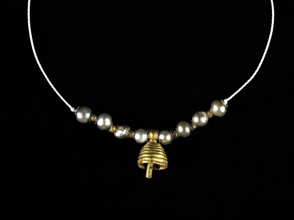 String of beads featuring a gold bell-shaped pendant, holed pearls, and gold spacer beads from the Achaemenid period. ancient Persian jewellery