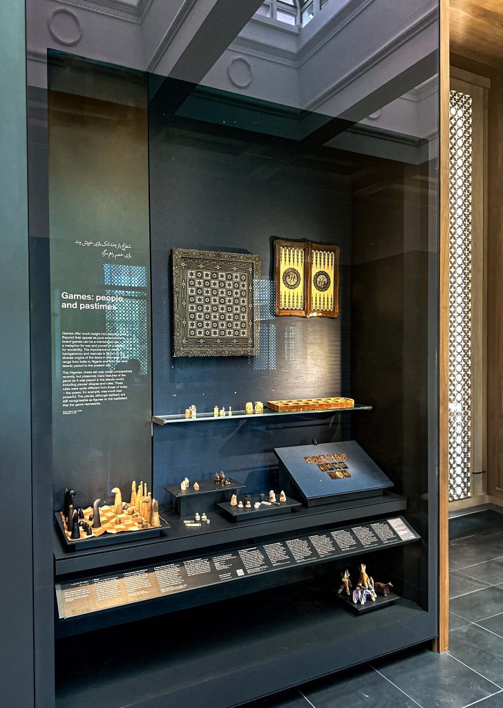 Collection of historical game boards and cards, including chess, backgammon, and Persian cards, displayed at the British Museum. History of Board Games