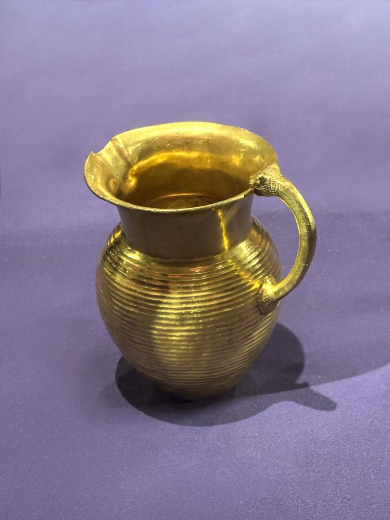 Exquisite Achaemenid gold jug from Oxus Treasure, showcasing meticulous craftsmanship and intricate details, reflecting the opulence of Persian drinks in the ancient world.