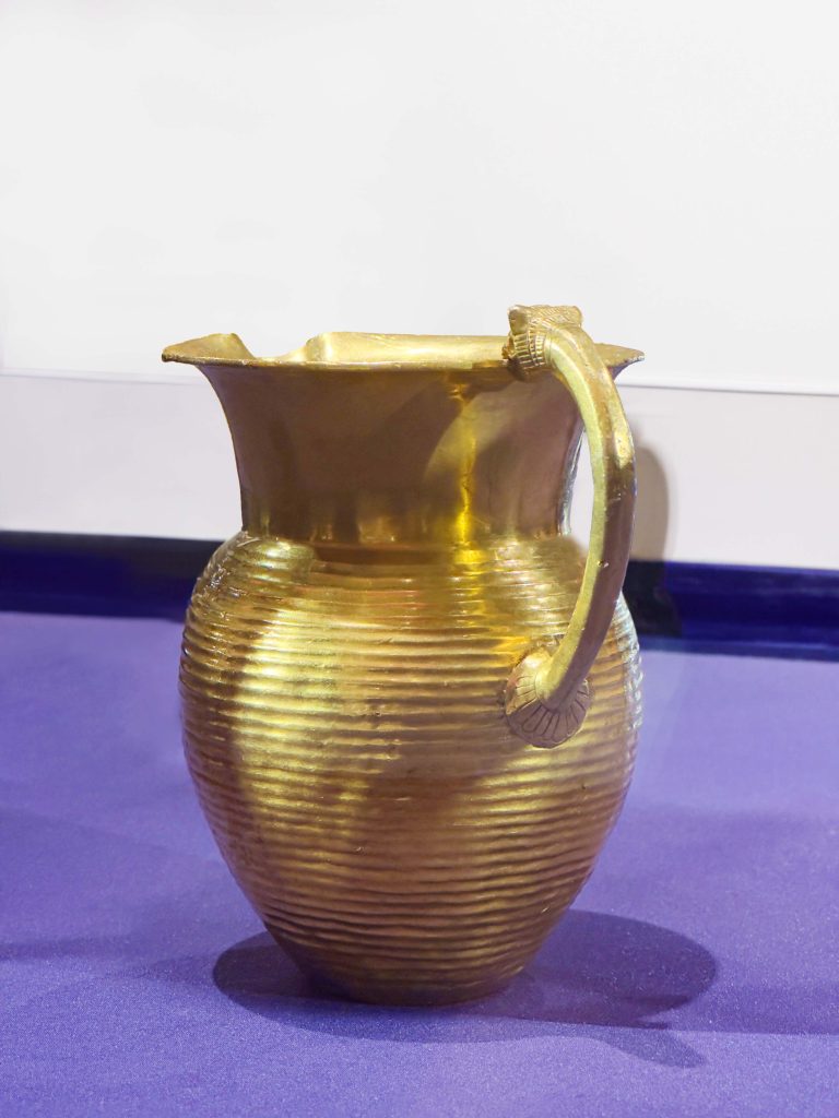 Exquisite Achaemenid gold jug from Oxus Treasure, showcasing meticulous craftsmanship and intricate details, reflecting the opulence of Persian drinks in the ancient world.