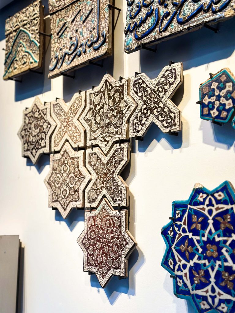 Eight-pointed star tile from the Ilkhanid dynasty with cypress tree and fishpond design, lustred and made of stonepaste, likely produced in Kashan. Persian Tile Artistry