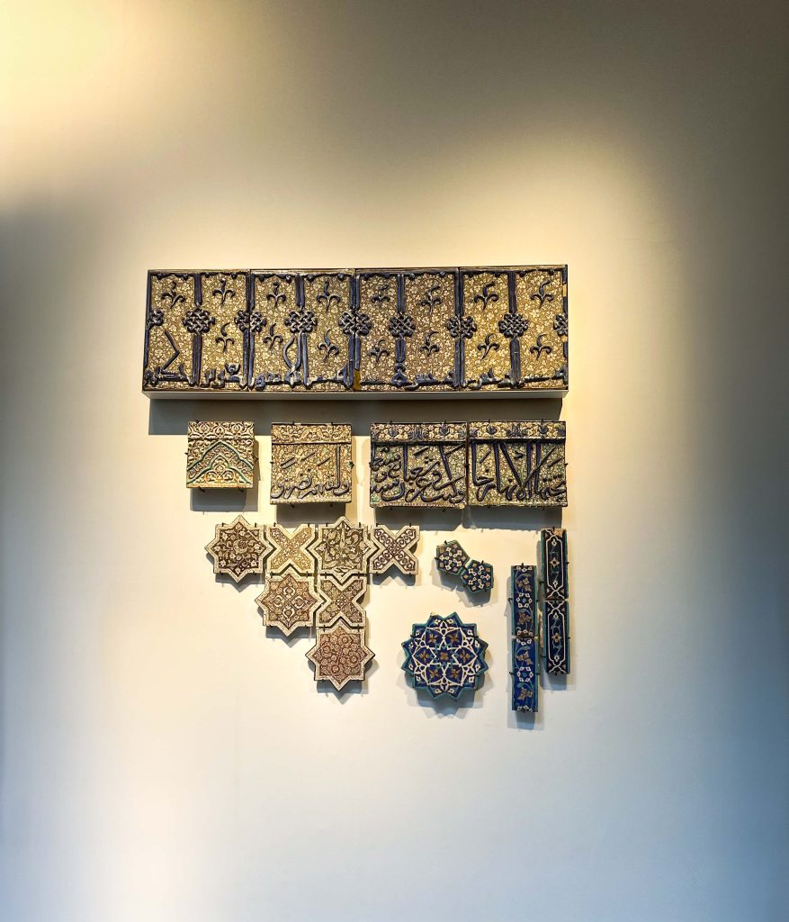 Collection of historical Persian tiles displayed at the British Museum, representing diverse eras and styles. Persian Tile Artistry