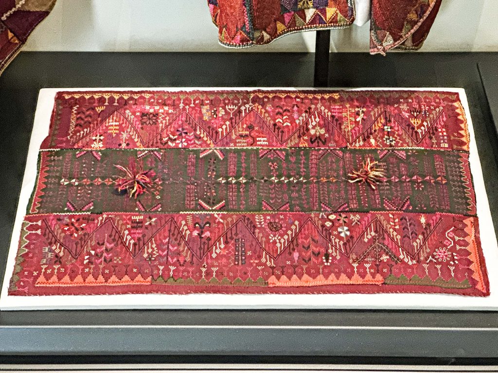 Embroidered satin silk cushion cover with vibrant colors, showcasing traditional Palestinian craftsmanship and Arabian design influences. Arabian clothing