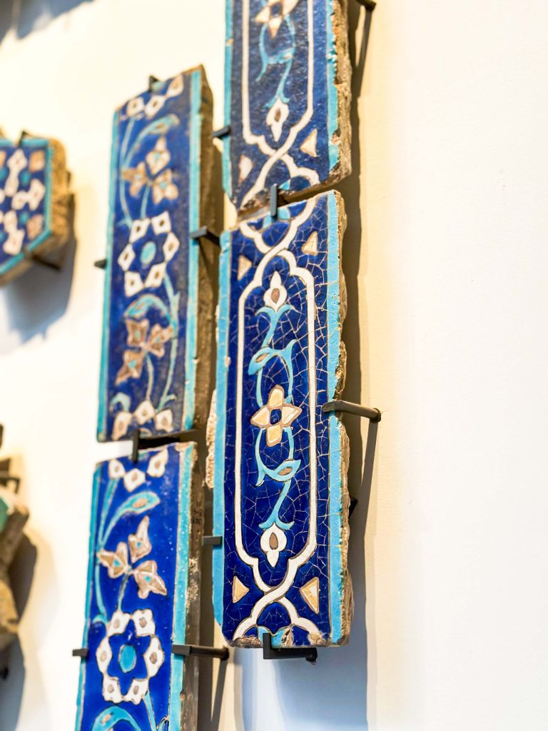 Gilded border tile with turquoise, cobalt, and white painted patterns from the Timurid dynasty, found in Bibi Khanum Mosque, Samarkand. Persian Tile Artistry