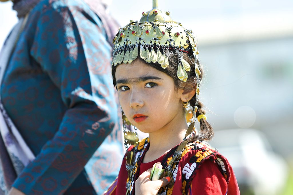 A Turkmen little girl showcases the beauty of traditional jewellery that represents her cultural heritage and status.