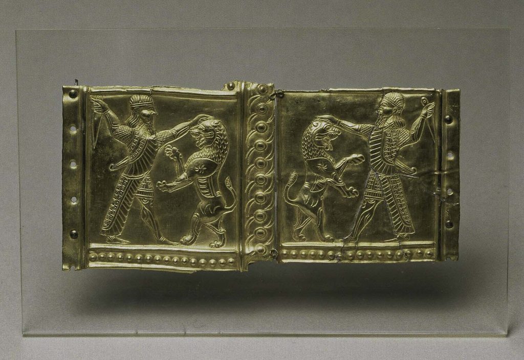 Gold plaque depicting a combatant fighting a lion, possibly part of a quiver decoration from the Ziwiye region.