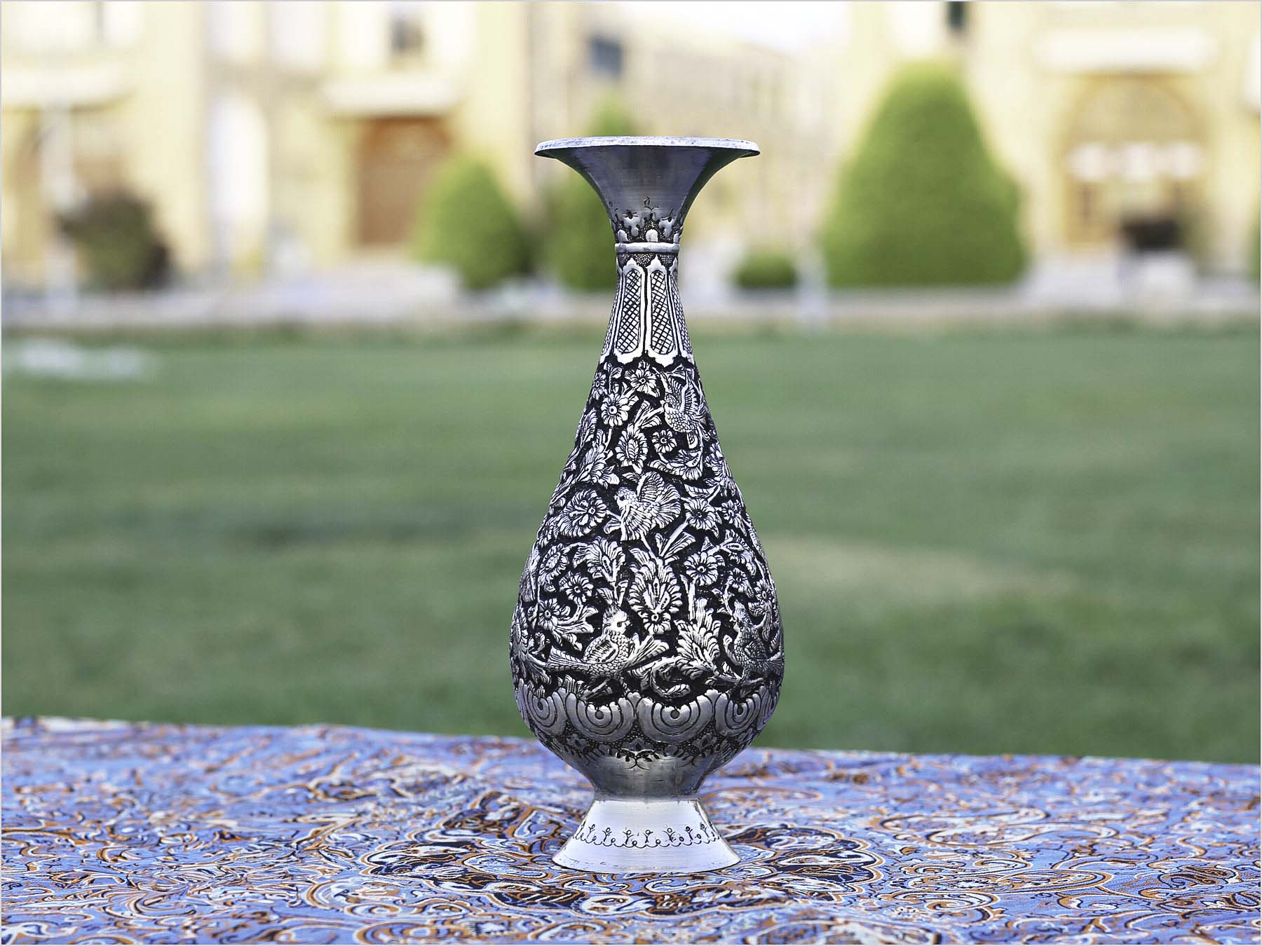 Handcrafted Persian Toreutics vase with floral engravings, made from copper and finished with tin and carbonic detailing. 25 cm height.