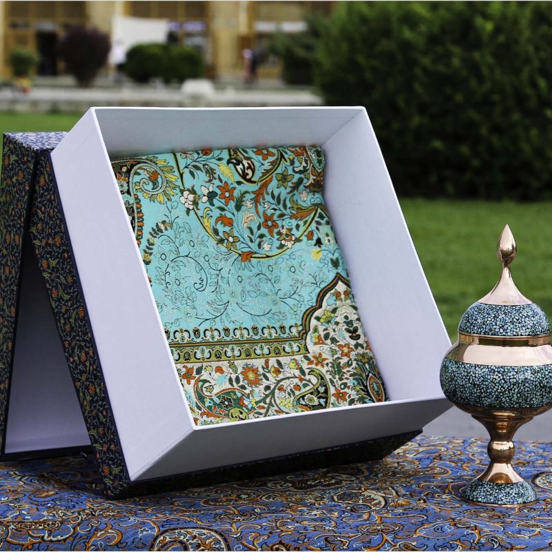 Turquoise-studded copper chocolate dish with traditional Persian Termeh tablecloth, displayed in an elegant gift box