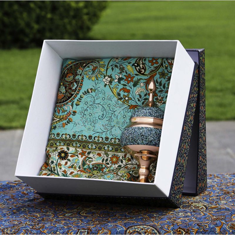 Turquoise-studded copper chocolate dish with traditional Persian Termeh tablecloth, displayed in an elegant gift box